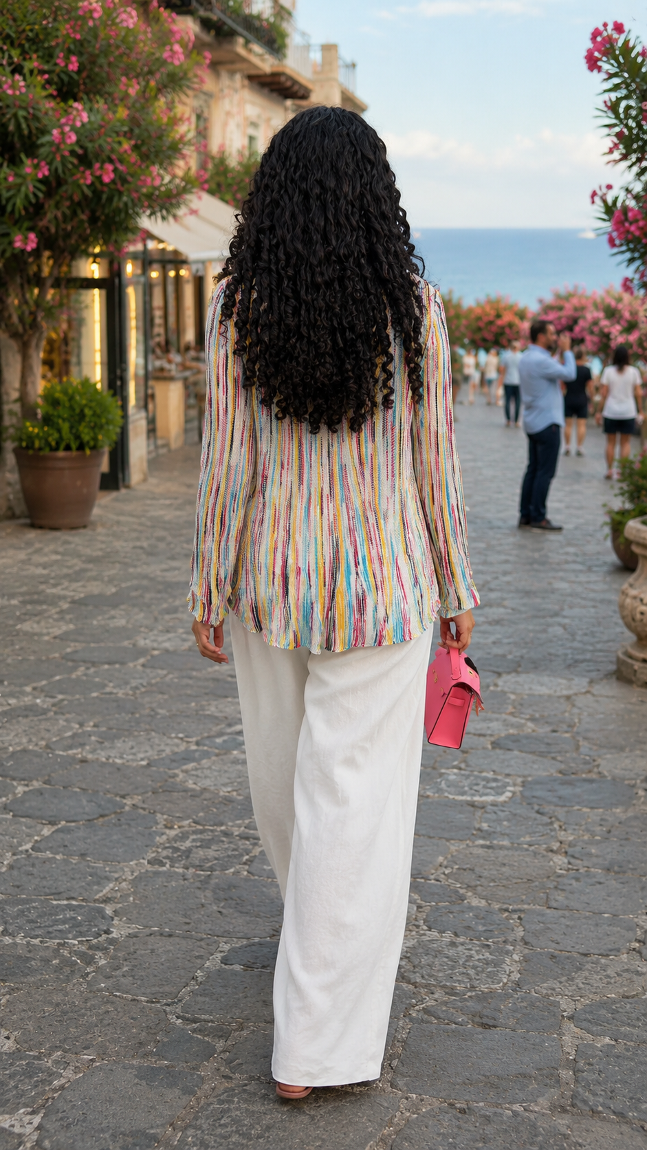 Back view of multicolor pleated stripe relaxed blouse showing soft drape and hip-length fit