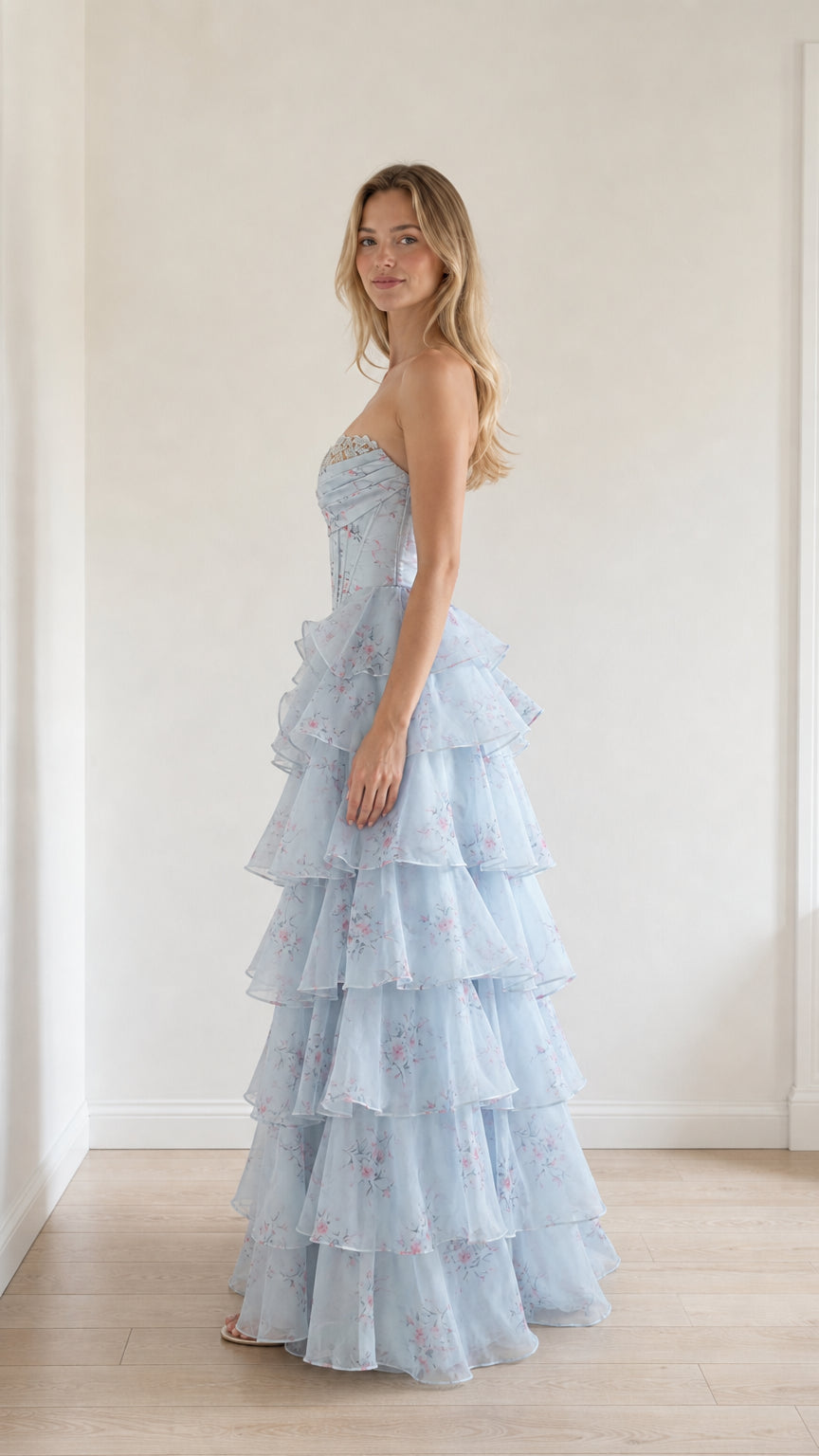 Side profile view of light blue floral tiered ruffle gown