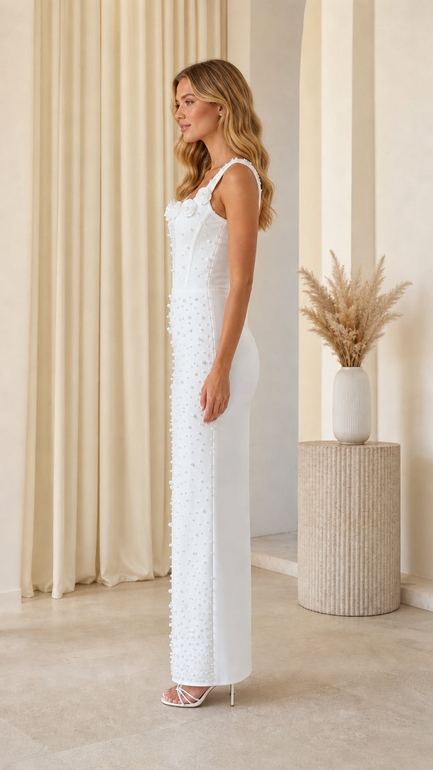 Side profile of model in white pearl embellished maxi dress