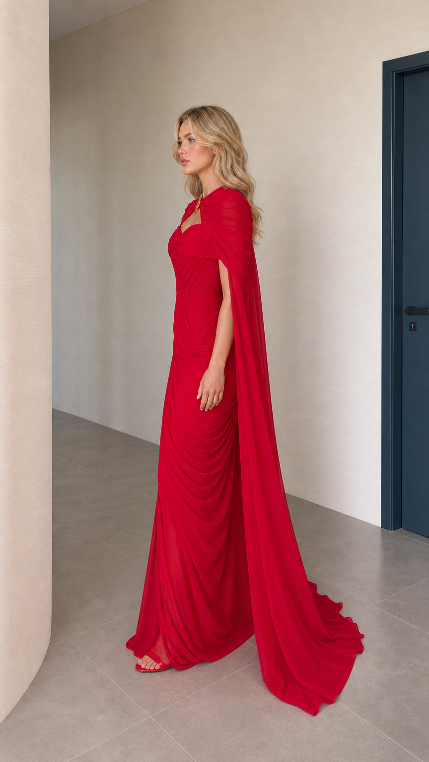 Side profile view of red cape evening gown