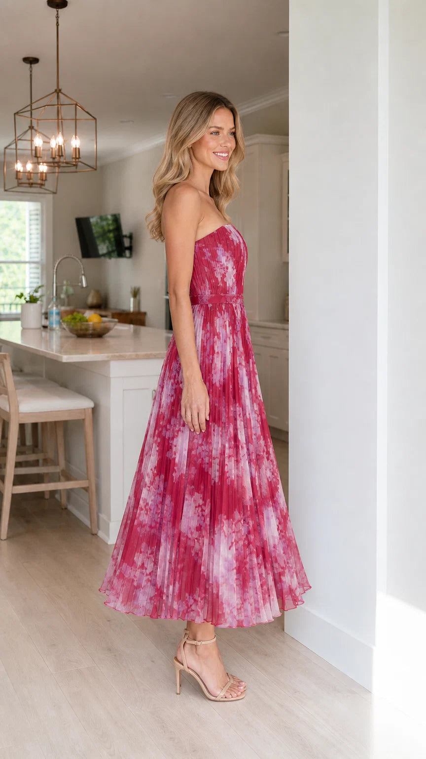 Side profile of woman in fuchsia floral midi dress