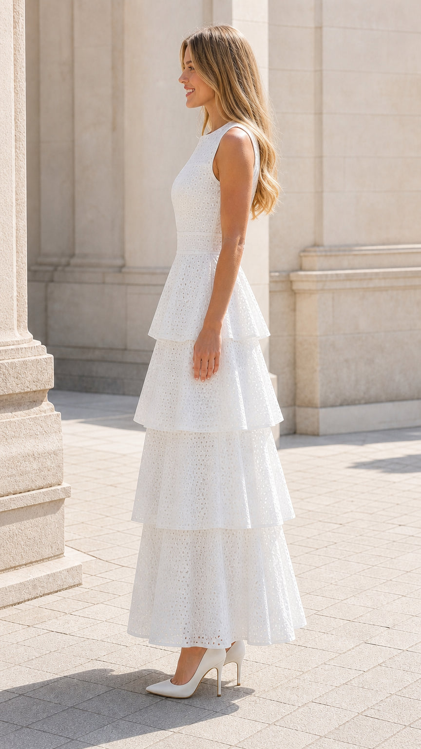 Side profile of woman in white tiered eyelet maxi dress
