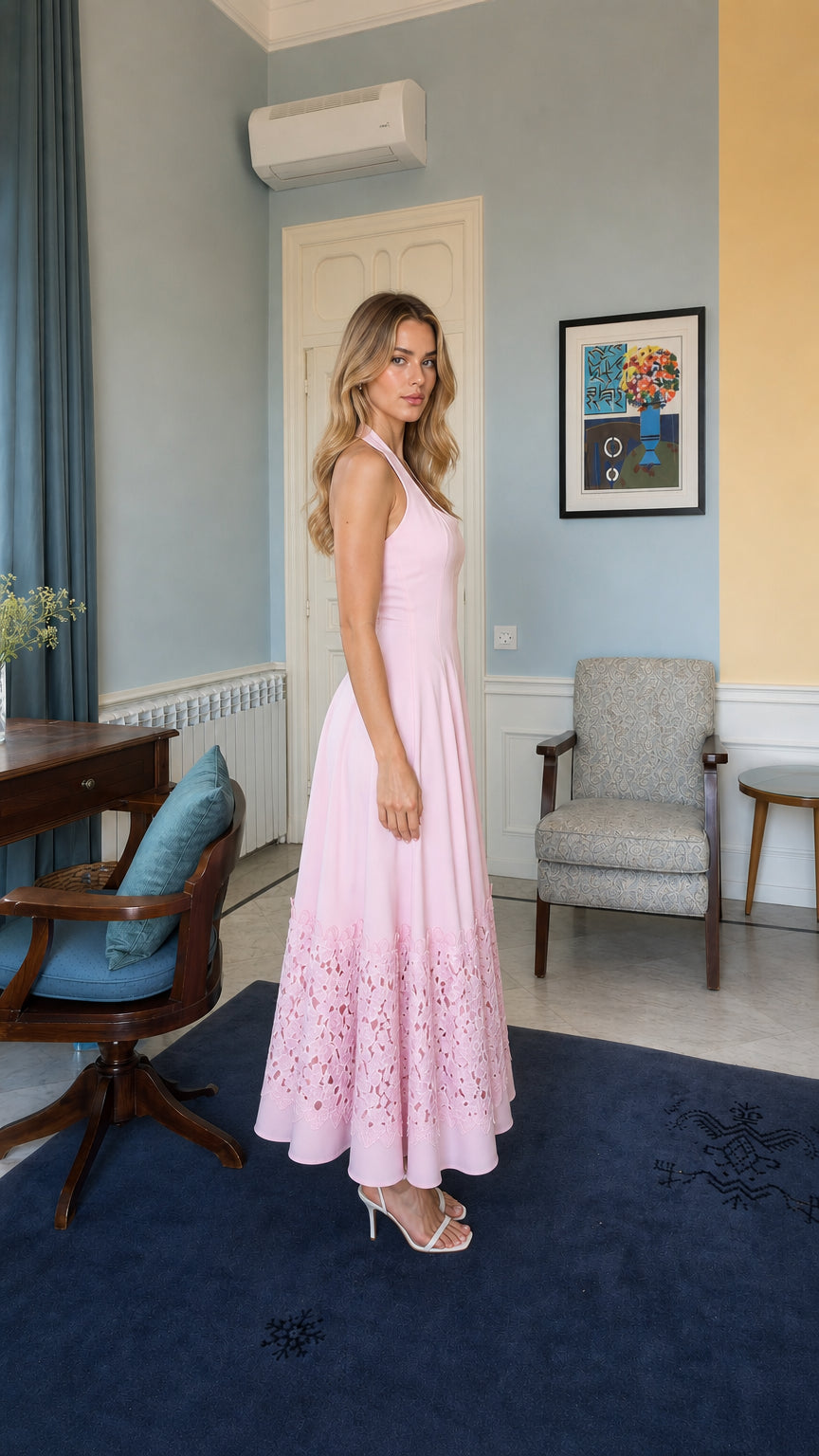 Side view of model wearing pink halter neck long dress