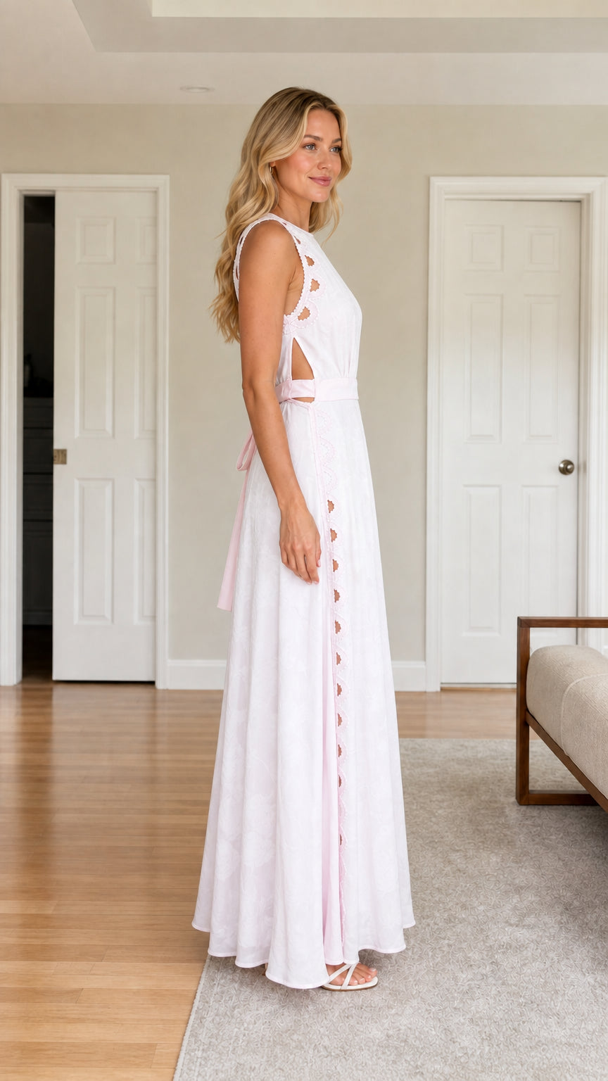 Side view of woman wearing white cutout maxi dress