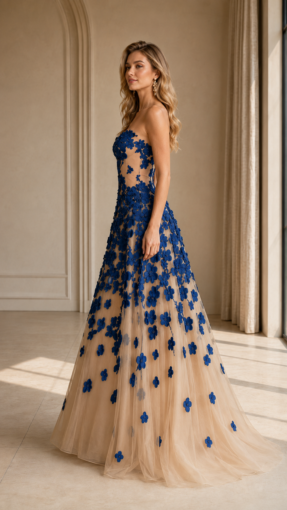 Side view of royal blue floral appliqué strapless tulle formal gown
