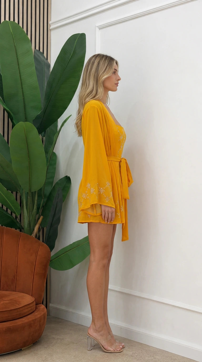 Side profile of model in yellow kimono set with clear heels