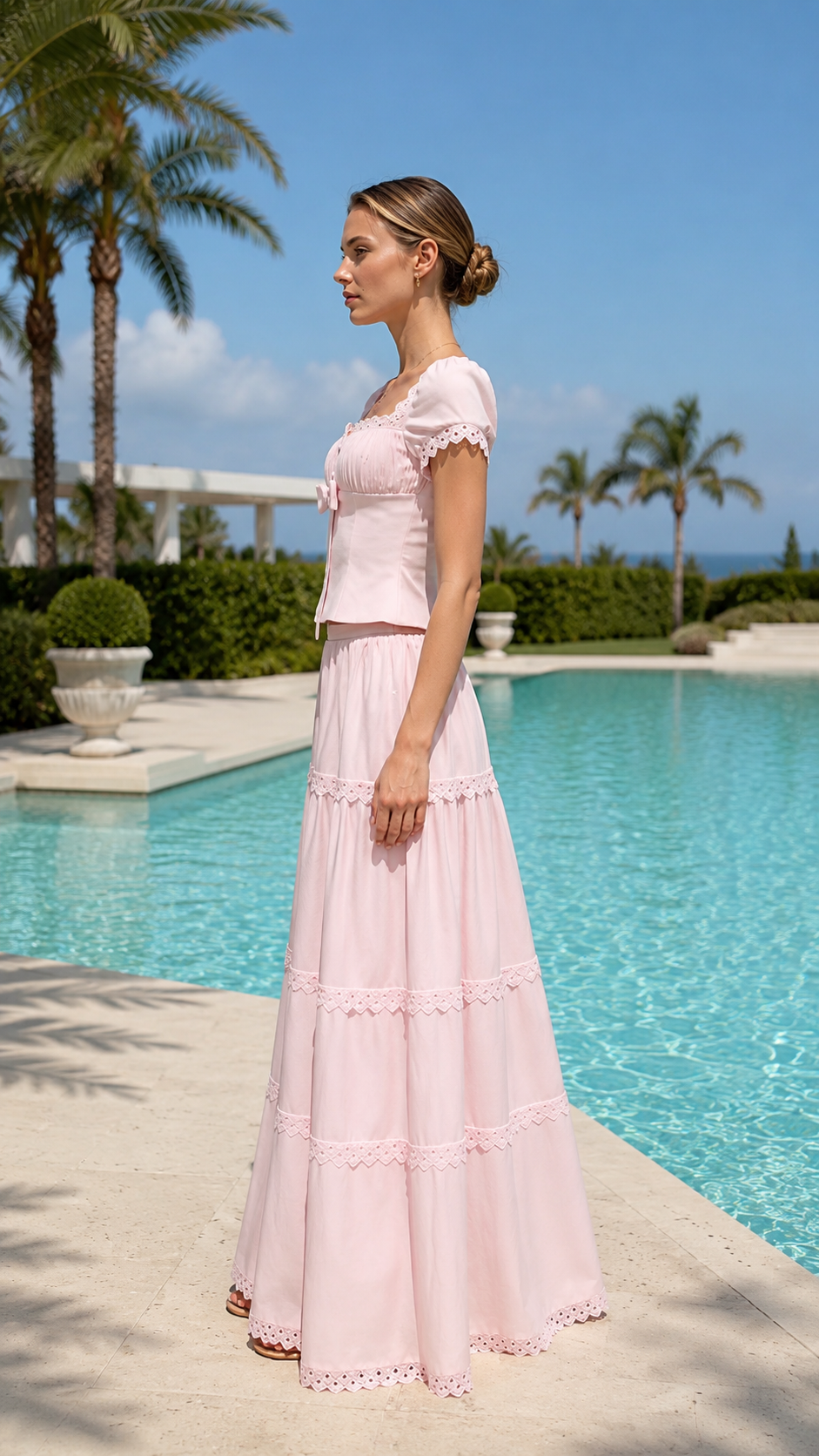 Side view of blush pink fitted bodice maxi dress with tiered full-length skirt