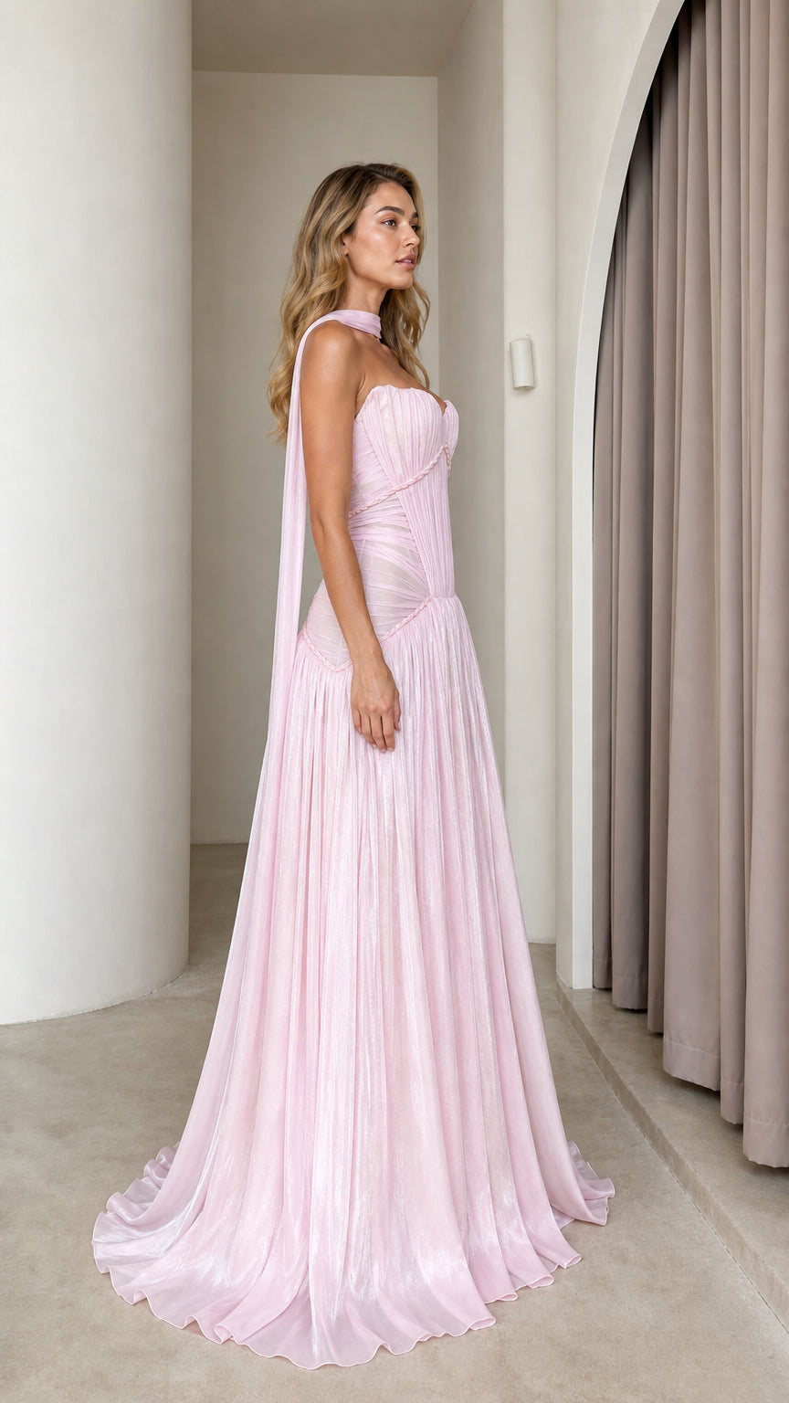 Side profile of pink pleated maxi dress with draping scarf