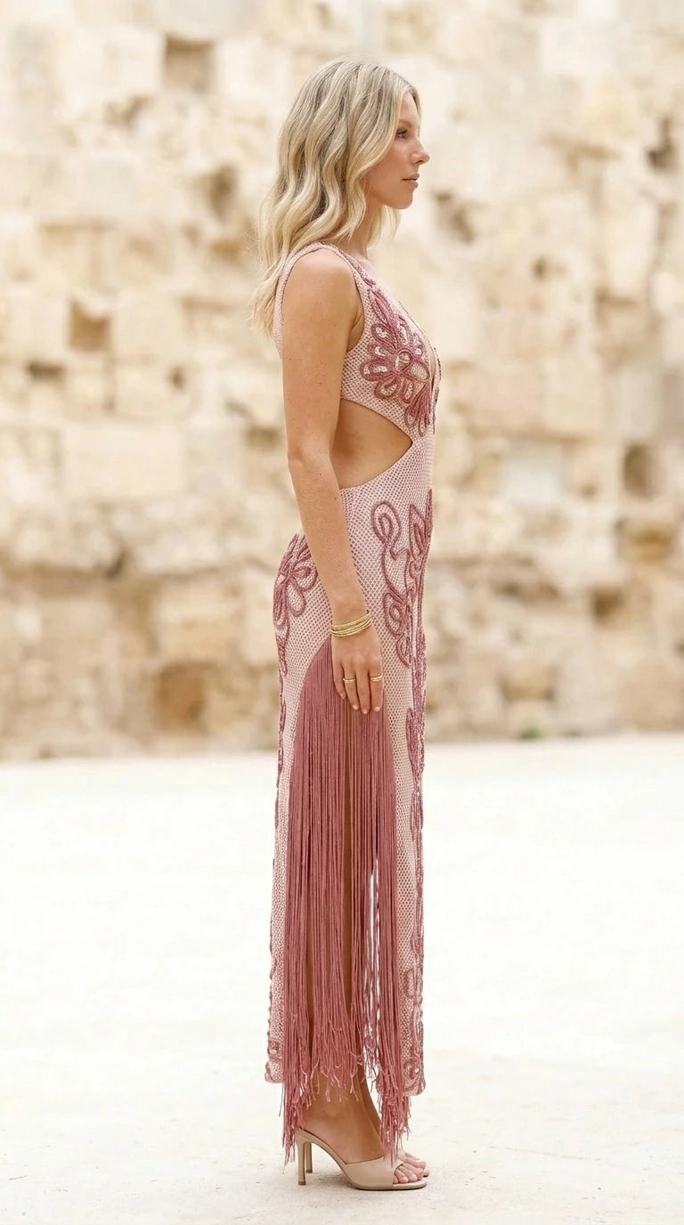 Side profile of model in pink fringe dress
