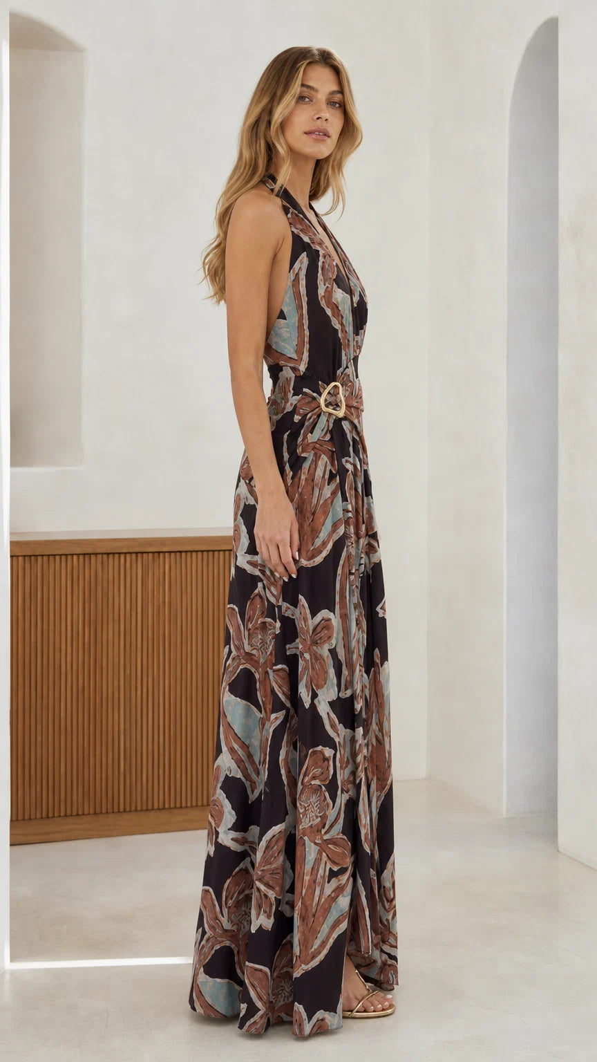 Side profile view of black abstract print halter maxi dress