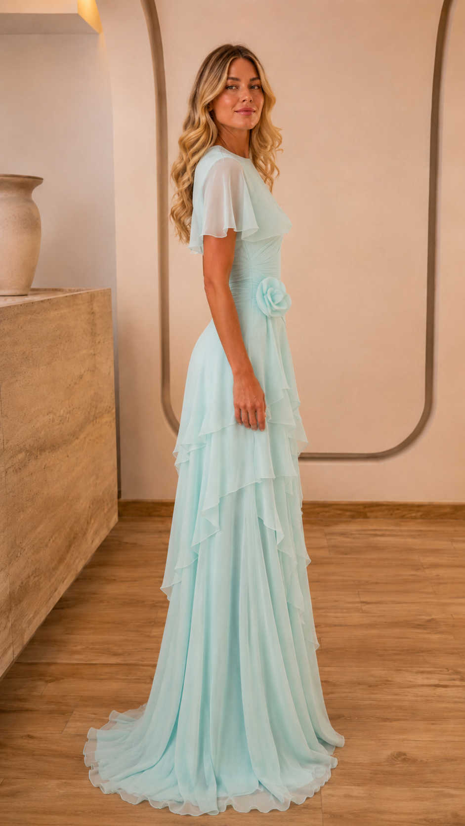 Side view of light blue floor-length ruffle dress with flutter sleeves and fitted waist