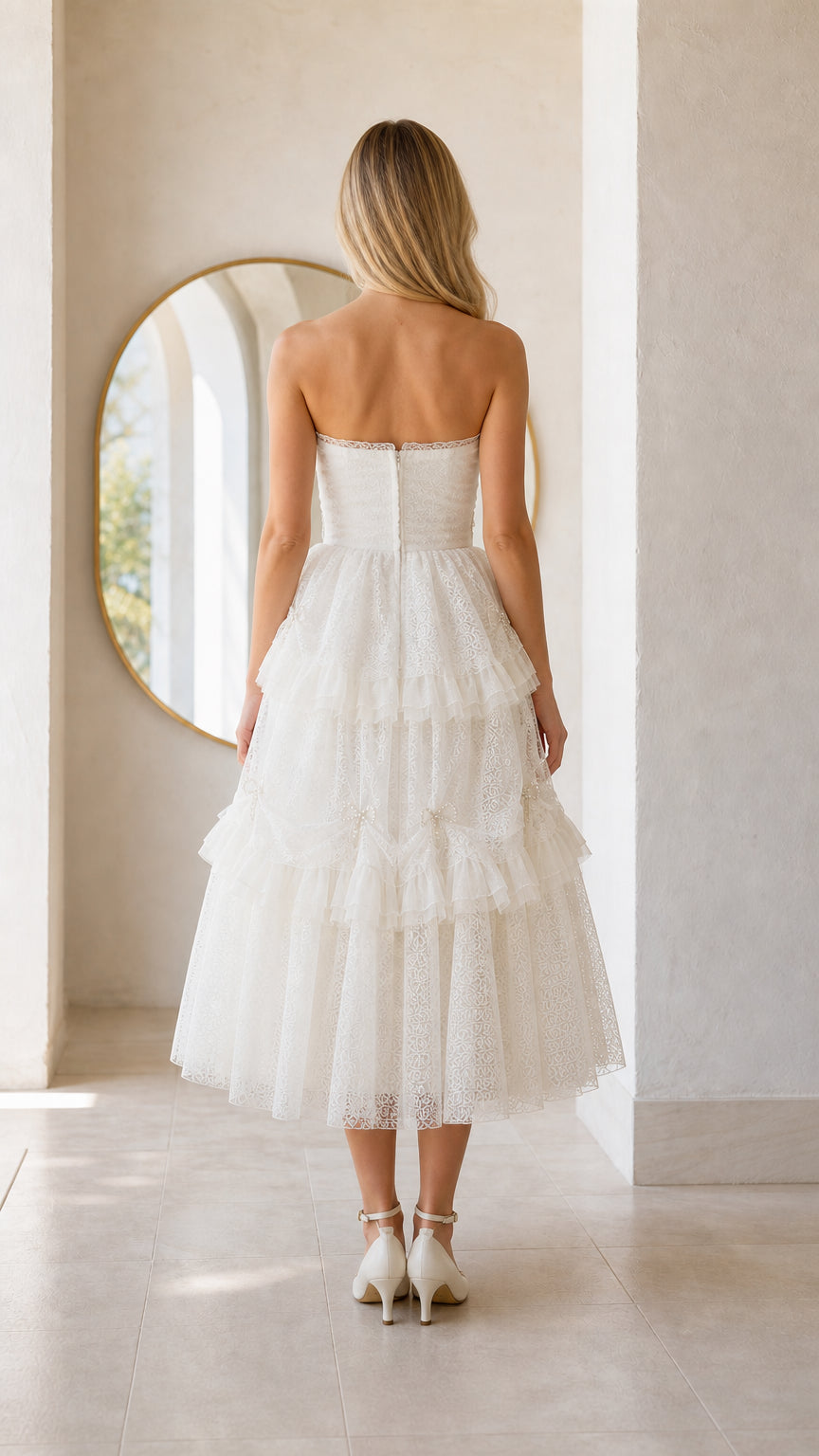 Back view of woman wearing white strapless midi dress