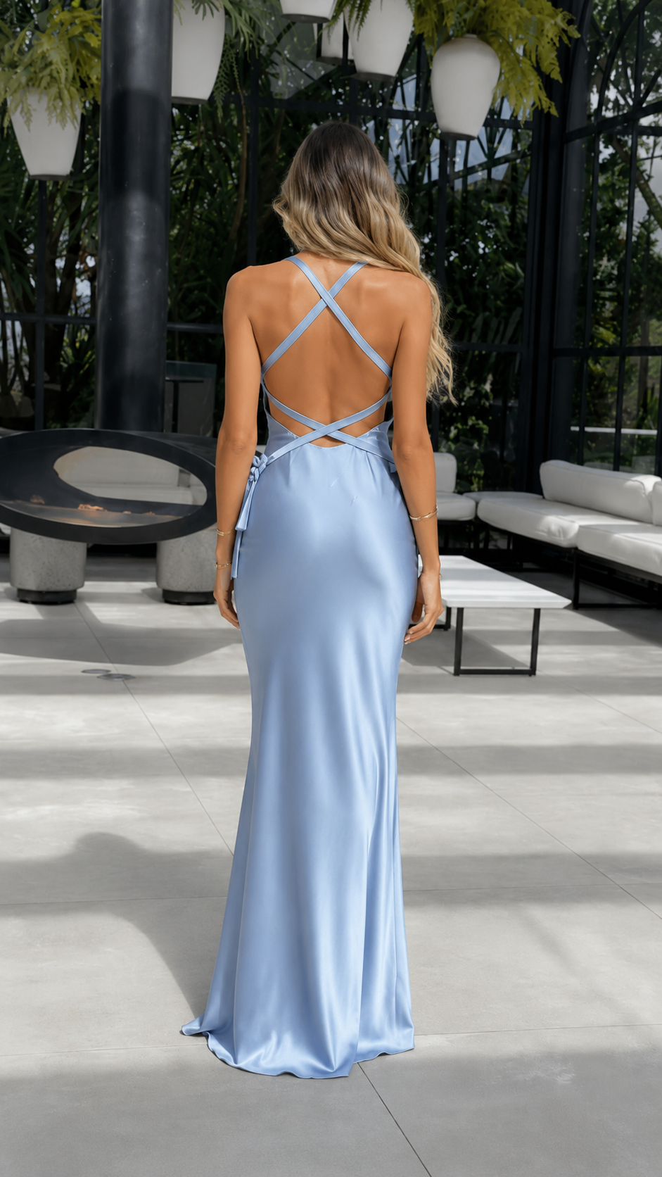 Back view of dusty blue maxi dress with crisscross straps and open back