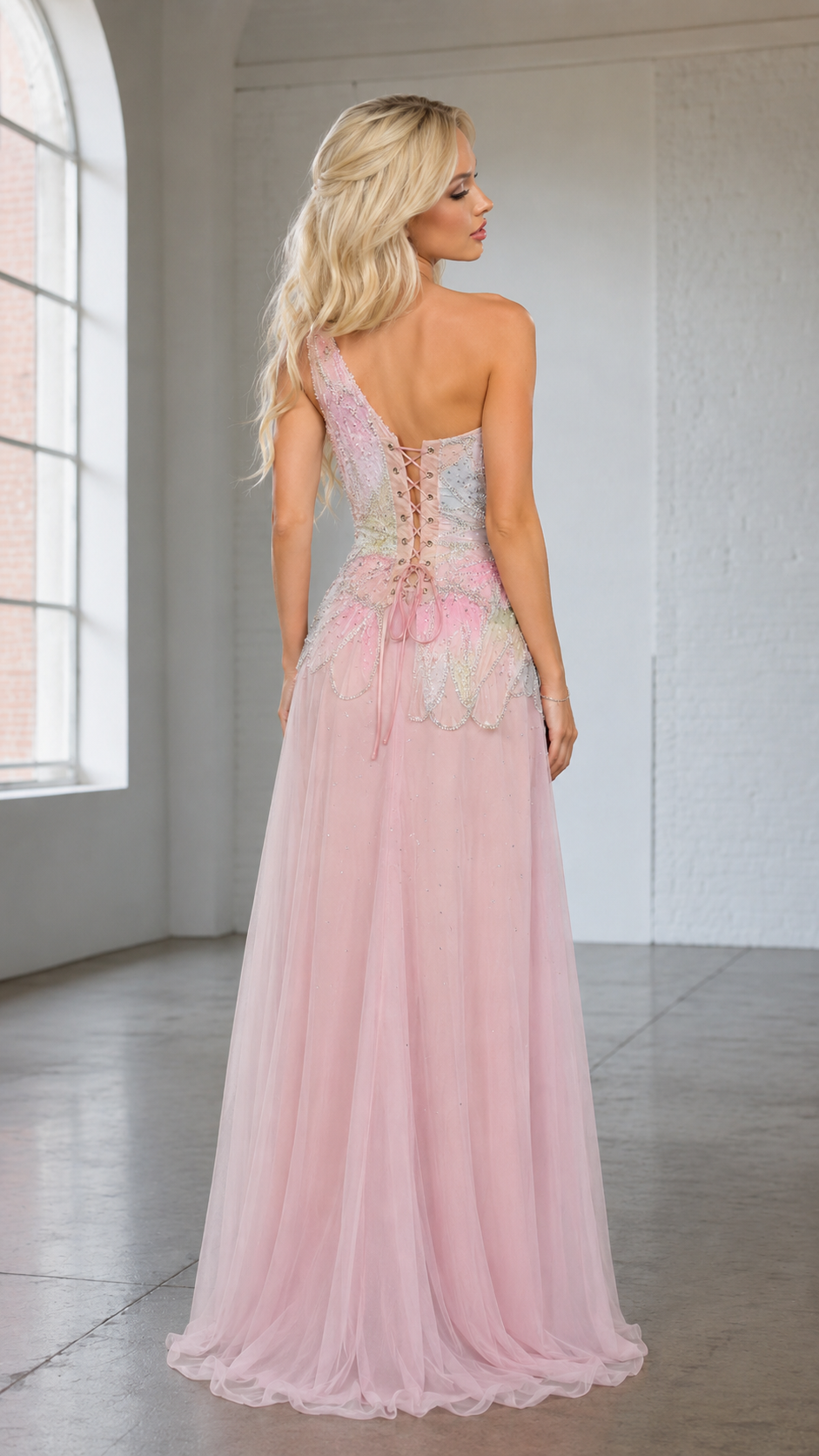Back view of blush pink evening gown with lace-up corset-style back and sheer skirt