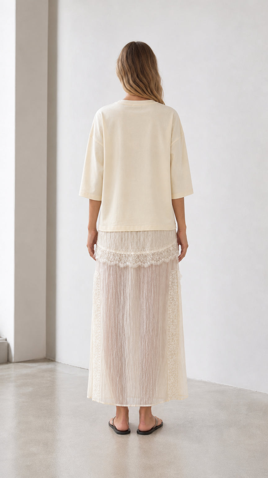 Back view of woman wearing cream tee and skirt set