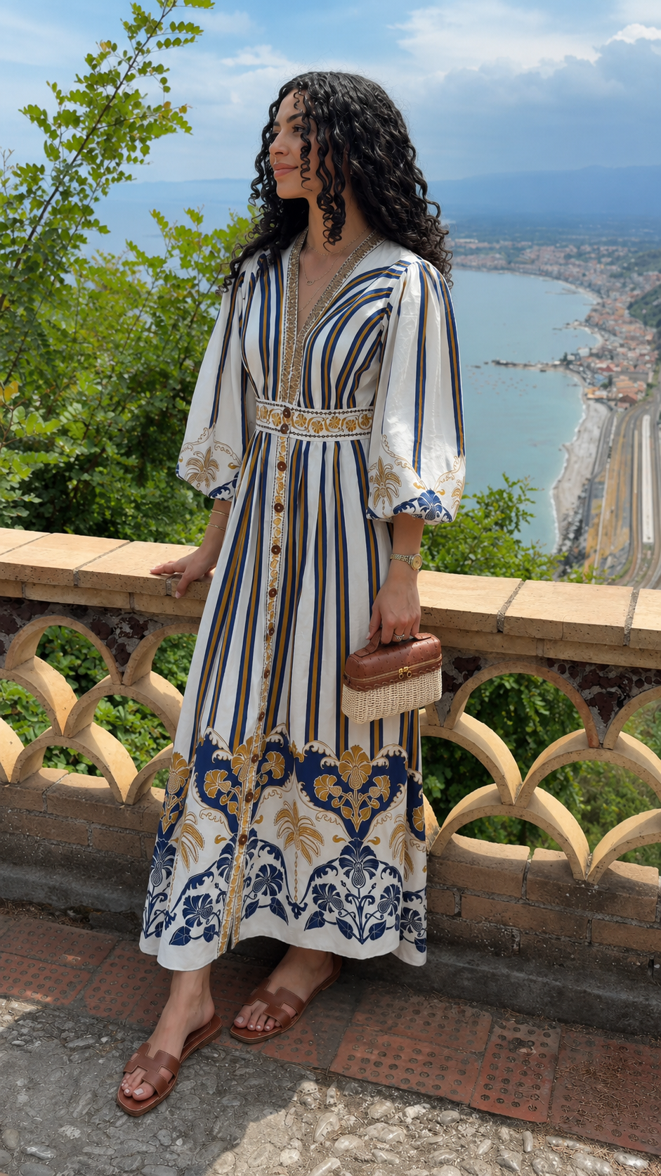 Angled front view of white printed puff sleeve maxi dress with deep V-neck