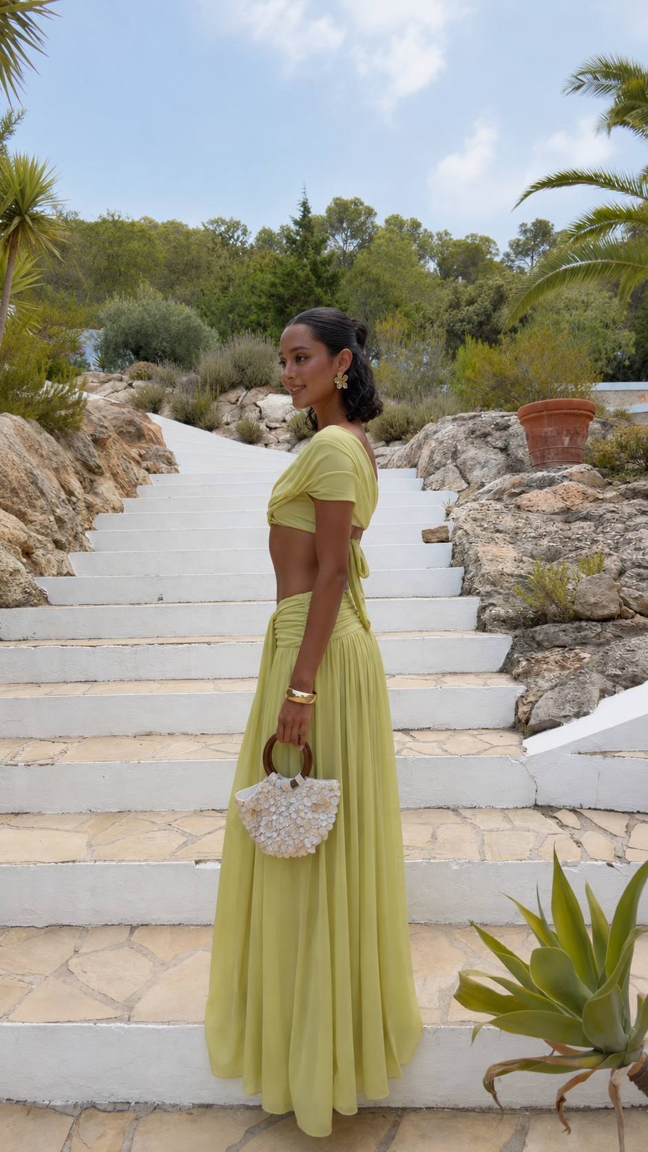 Side view of pistachio draped off-shoulder top and floor-length skirt set