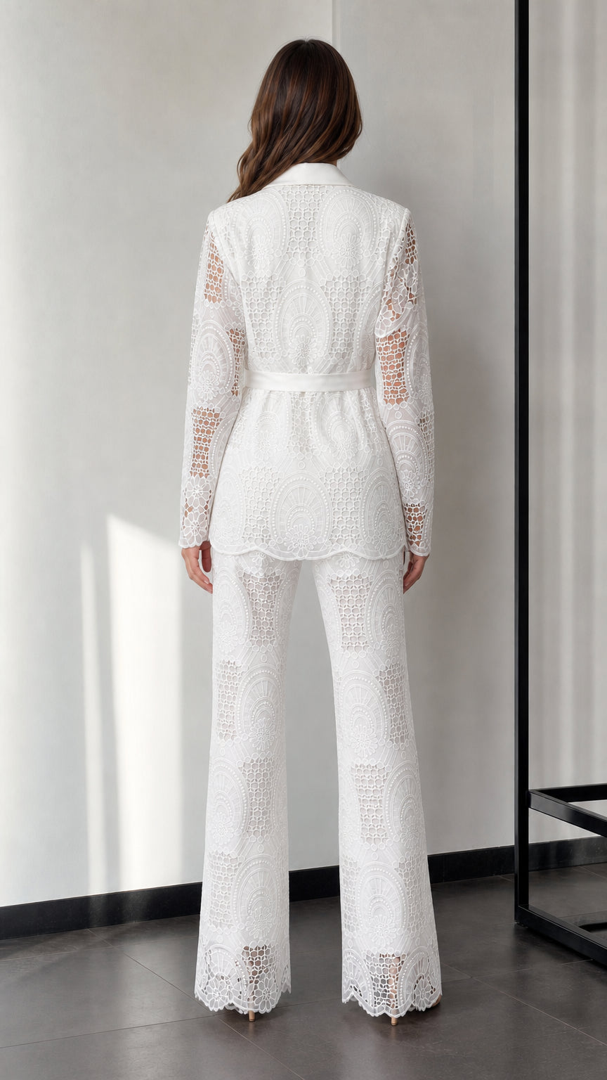 Back view of woman wearing white lace two-piece suit