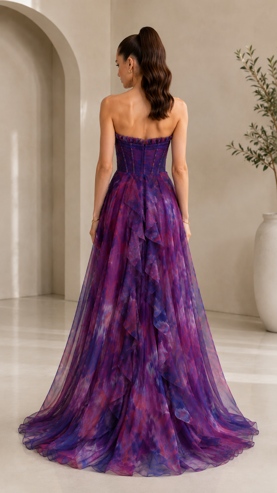 Back view of purple printed strapless corset-style evening dress with full train effect