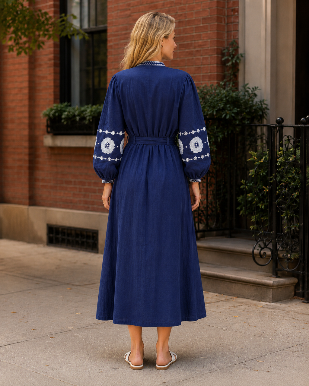 Cobalt blue embroidered midi dress back view with long sleeves and tie waist