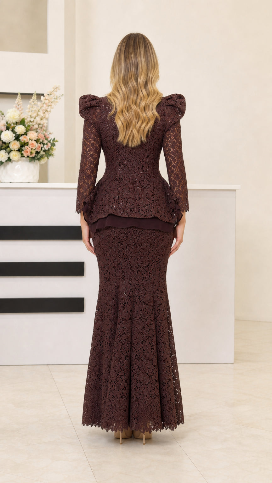 Back view of dark brown lace evening dress with peplum detail