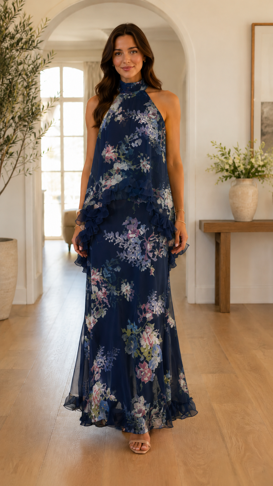 Front view of navy floral halter neck maxi dress with layered draped overlay