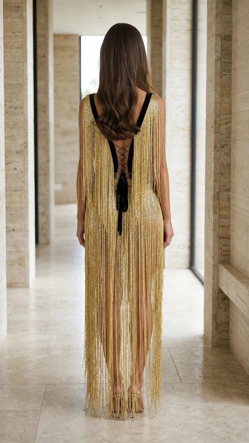 Back view of gold fringe dress featuring lace-up closure