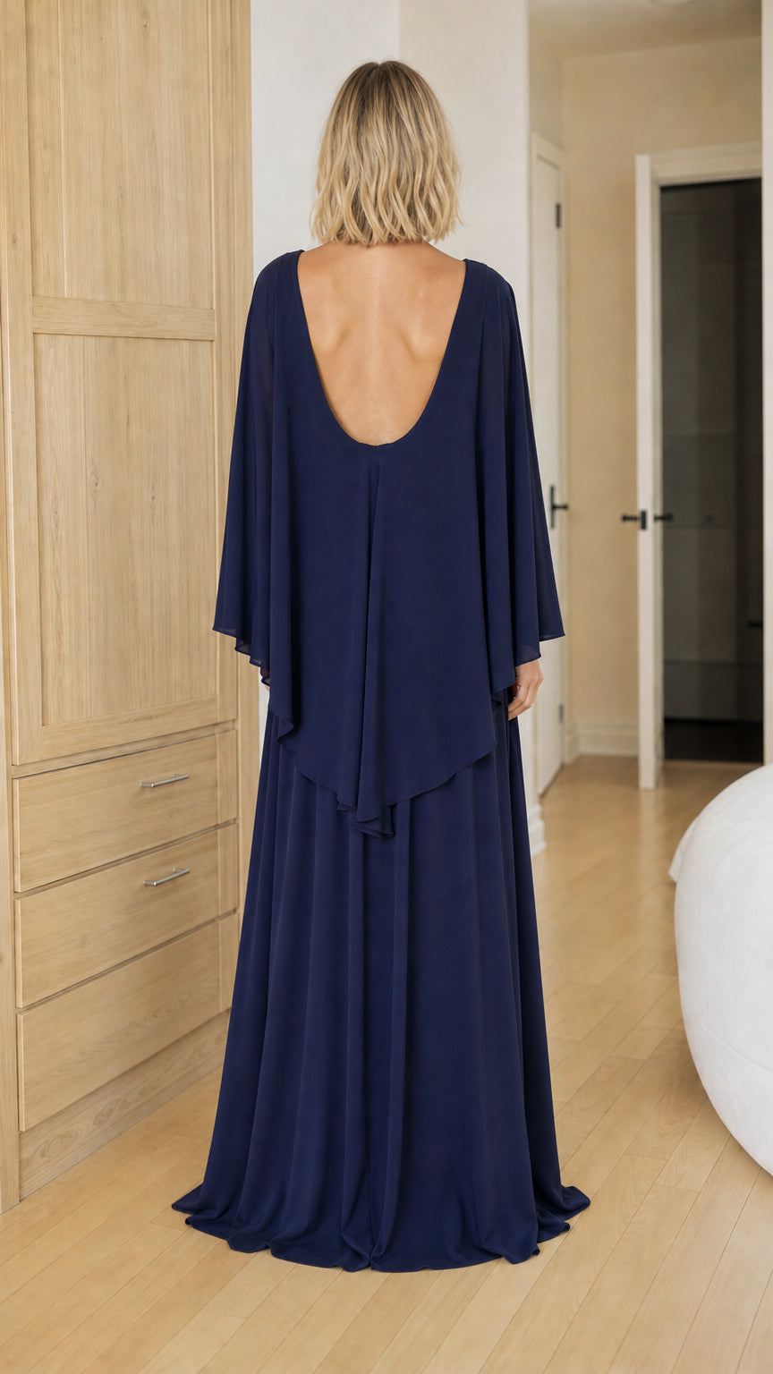 Back view of navy blue formal dress featuring scoop back and cape