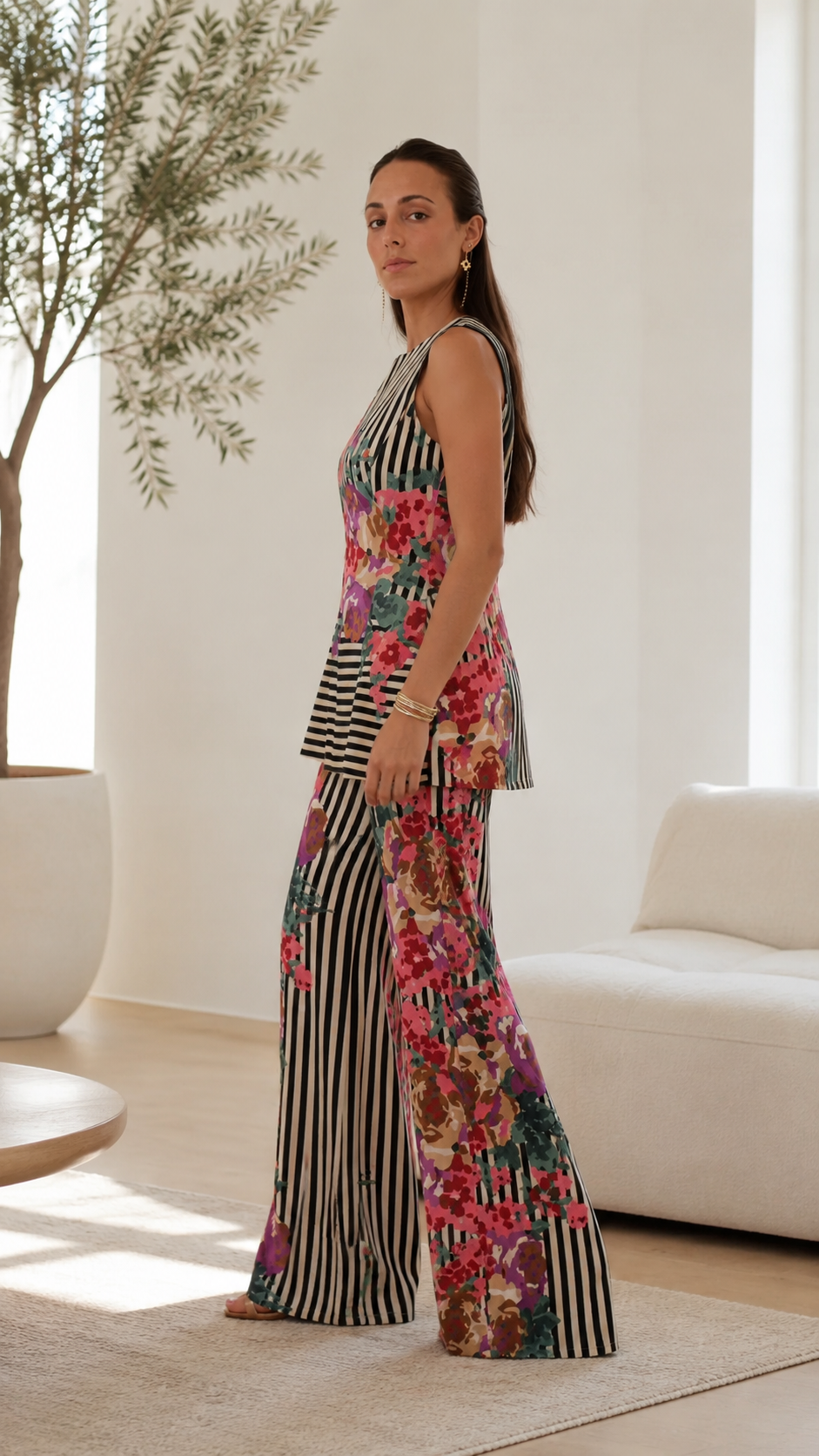 Side view of black striped floral sleeveless tunic and matching wide-leg pants set