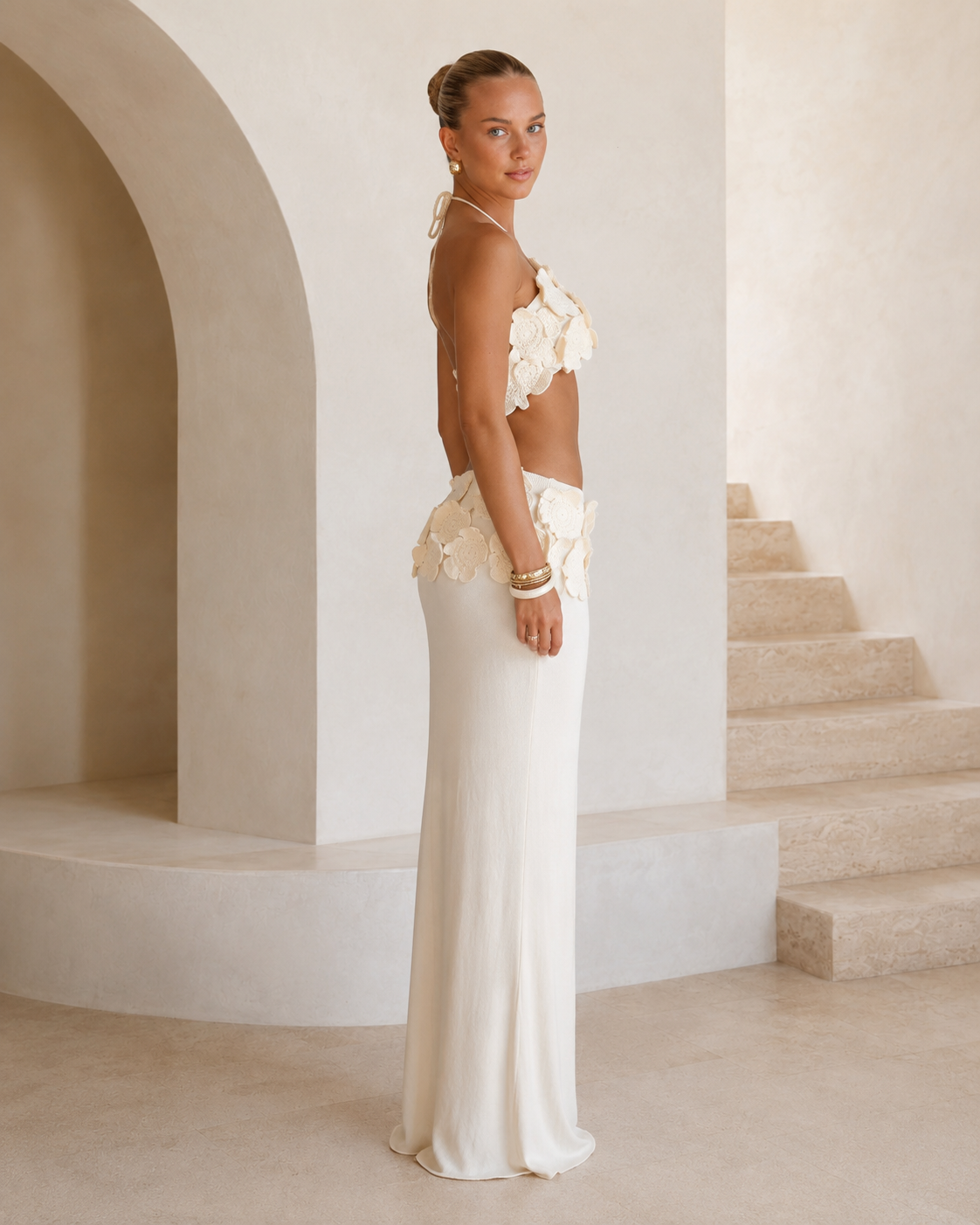 Side view of ivory 3D floral halter crop top and matching ivory maxi skirt set