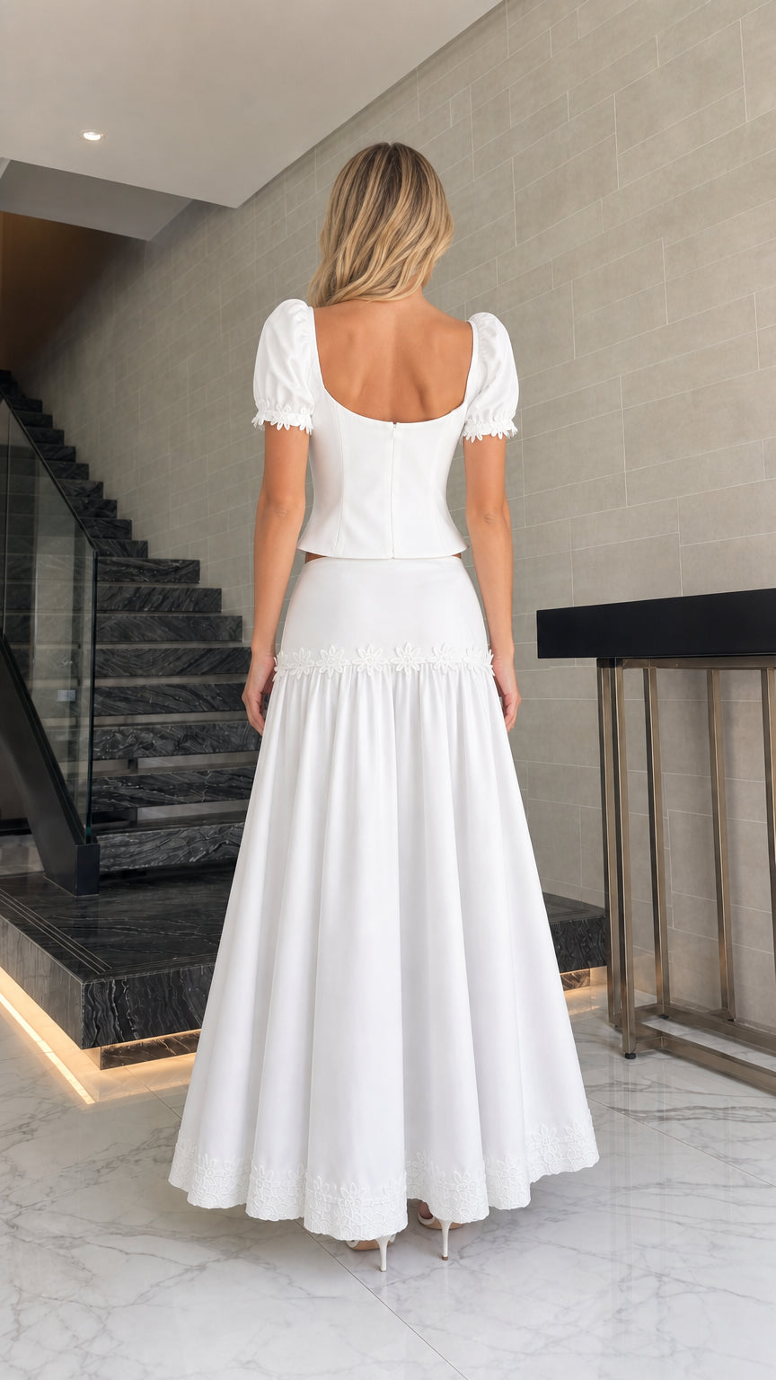 Back view of model in white puff sleeve top and maxi skirt