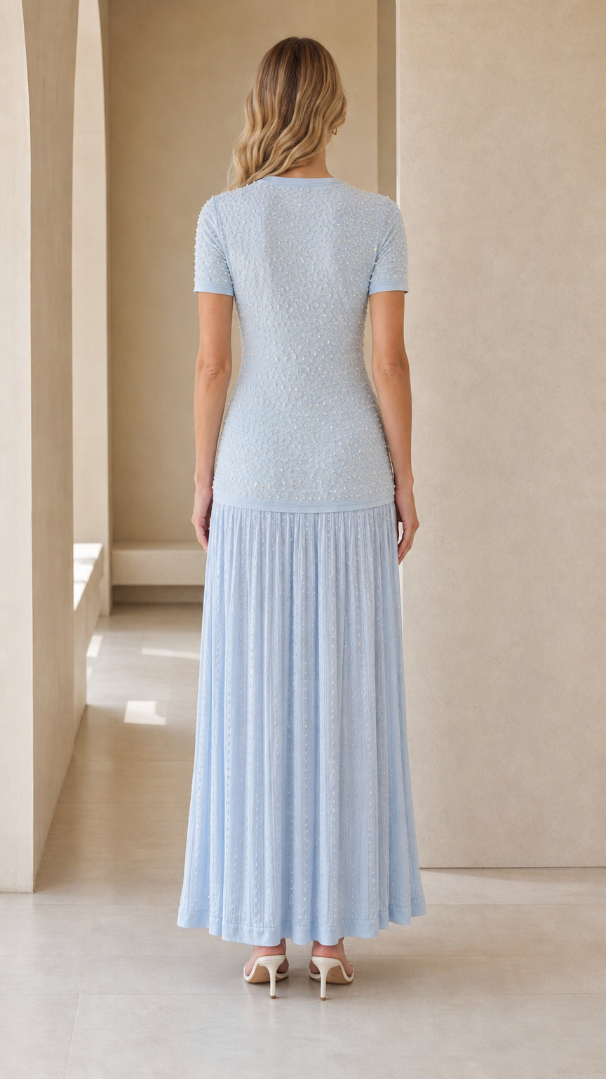 Back view of model in light blue textured knit maxi dress
