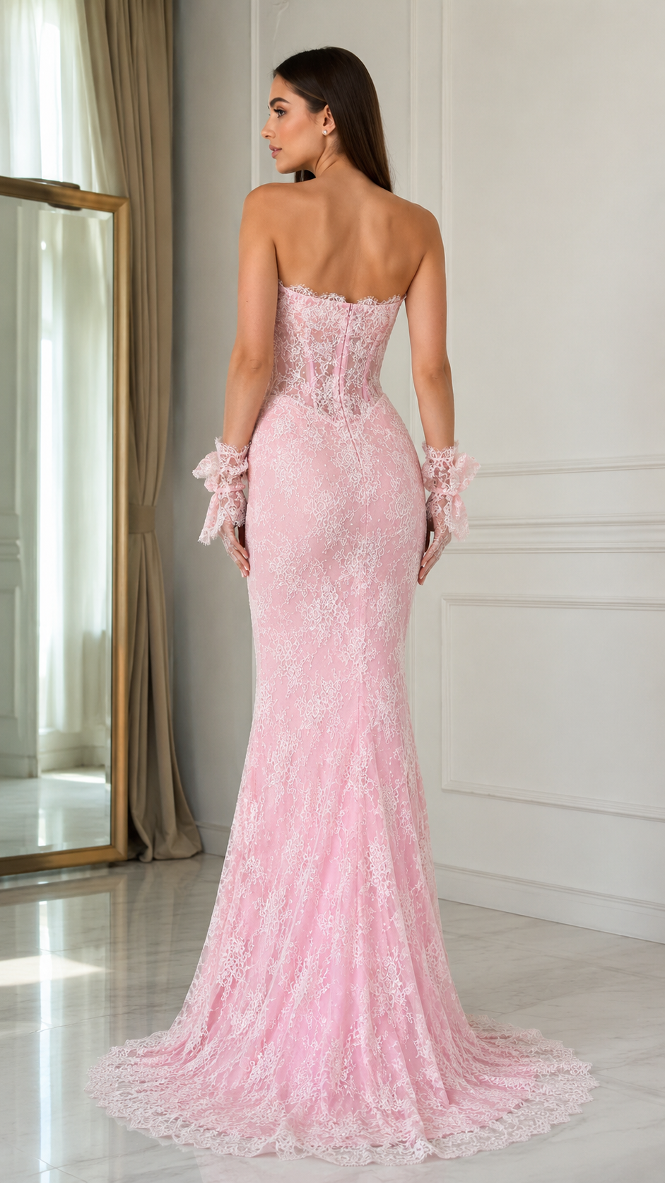 Back view of blush pink strapless mermaid gown with lace overlay and floor-sweeping train