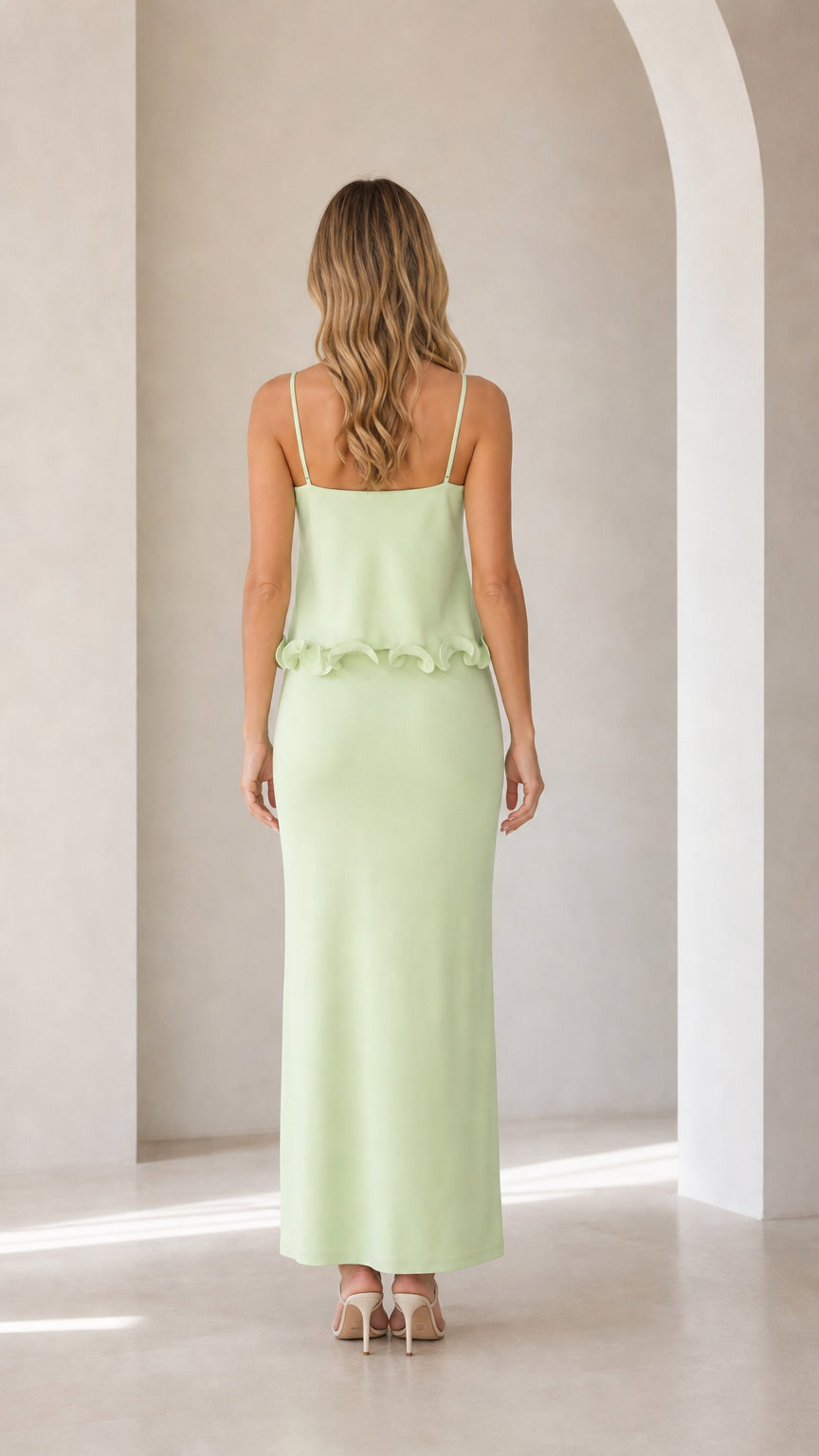 Back view of model in sage green maxi dress