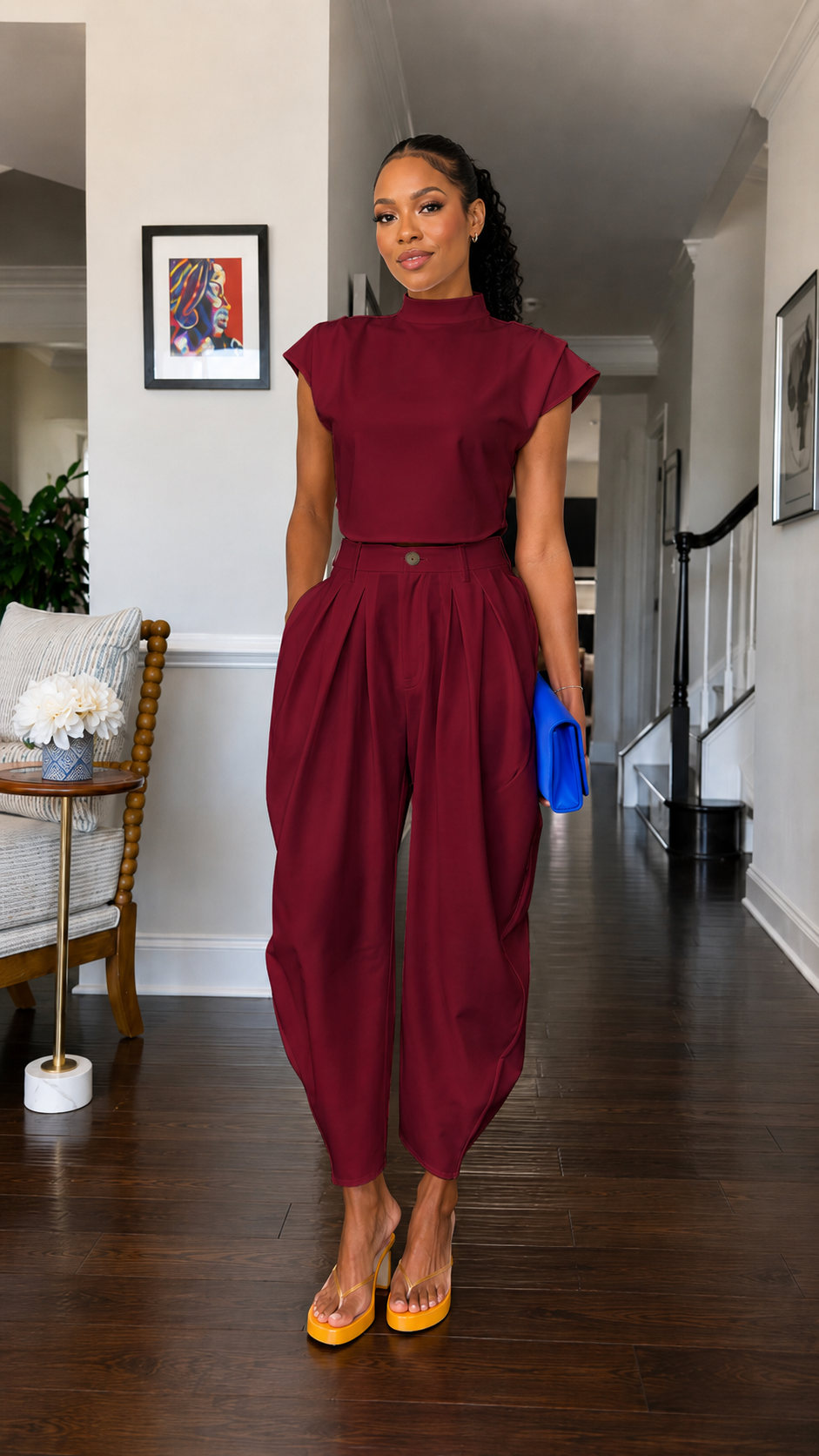 Front view of burgundy mock neck cap sleeve harem jumpsuit with pleated front