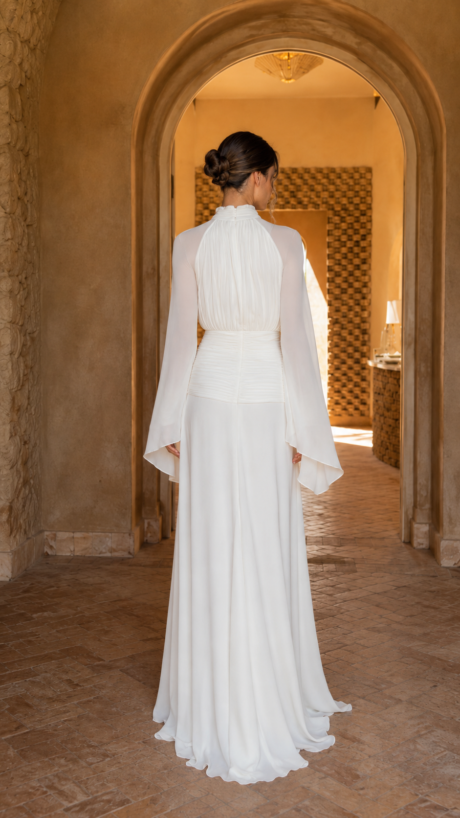 Back view of ivory formal maxi dress with flowing skirt and long bell sleeves