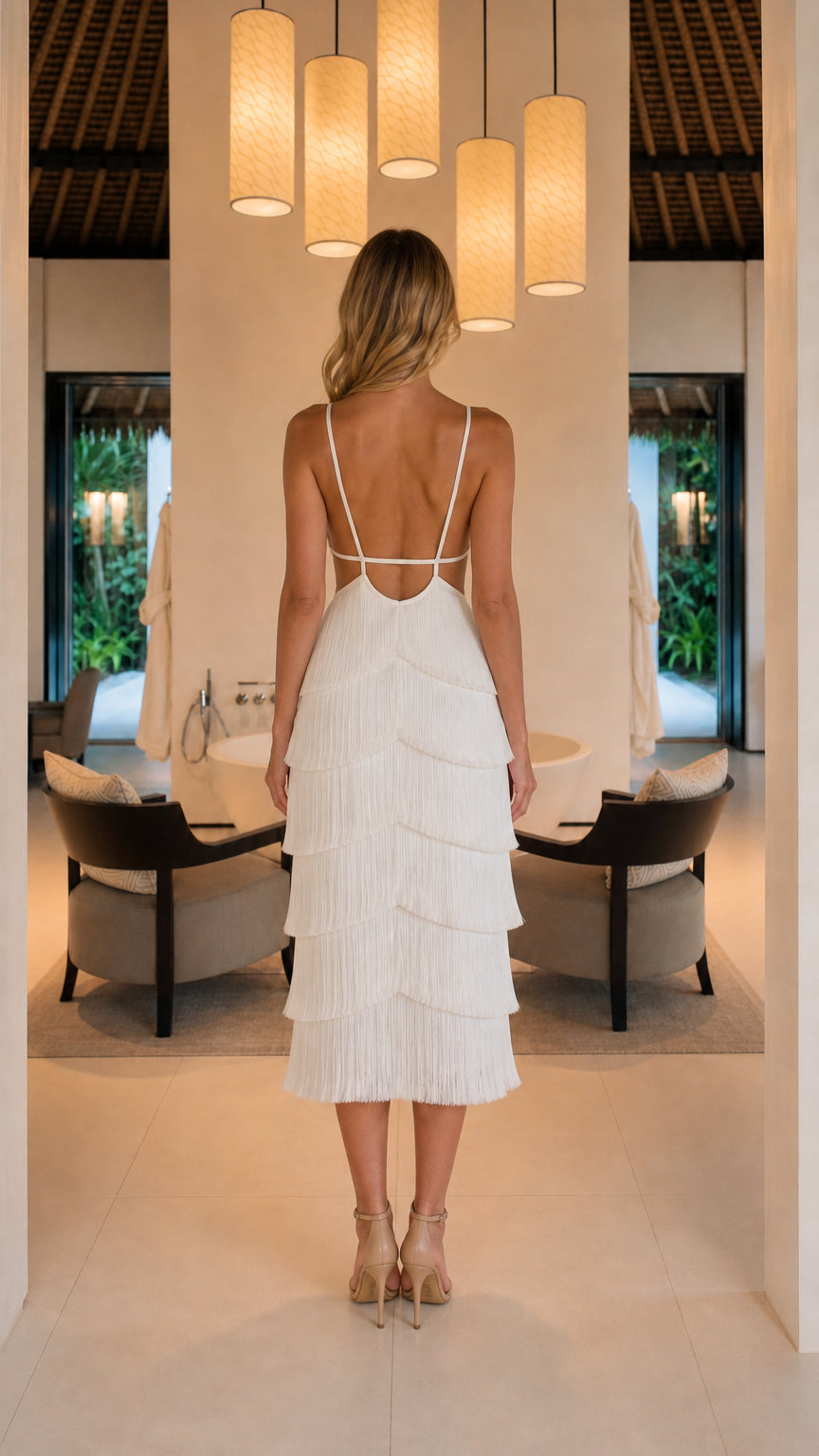 Back view showing open back and straps of white fringe dress