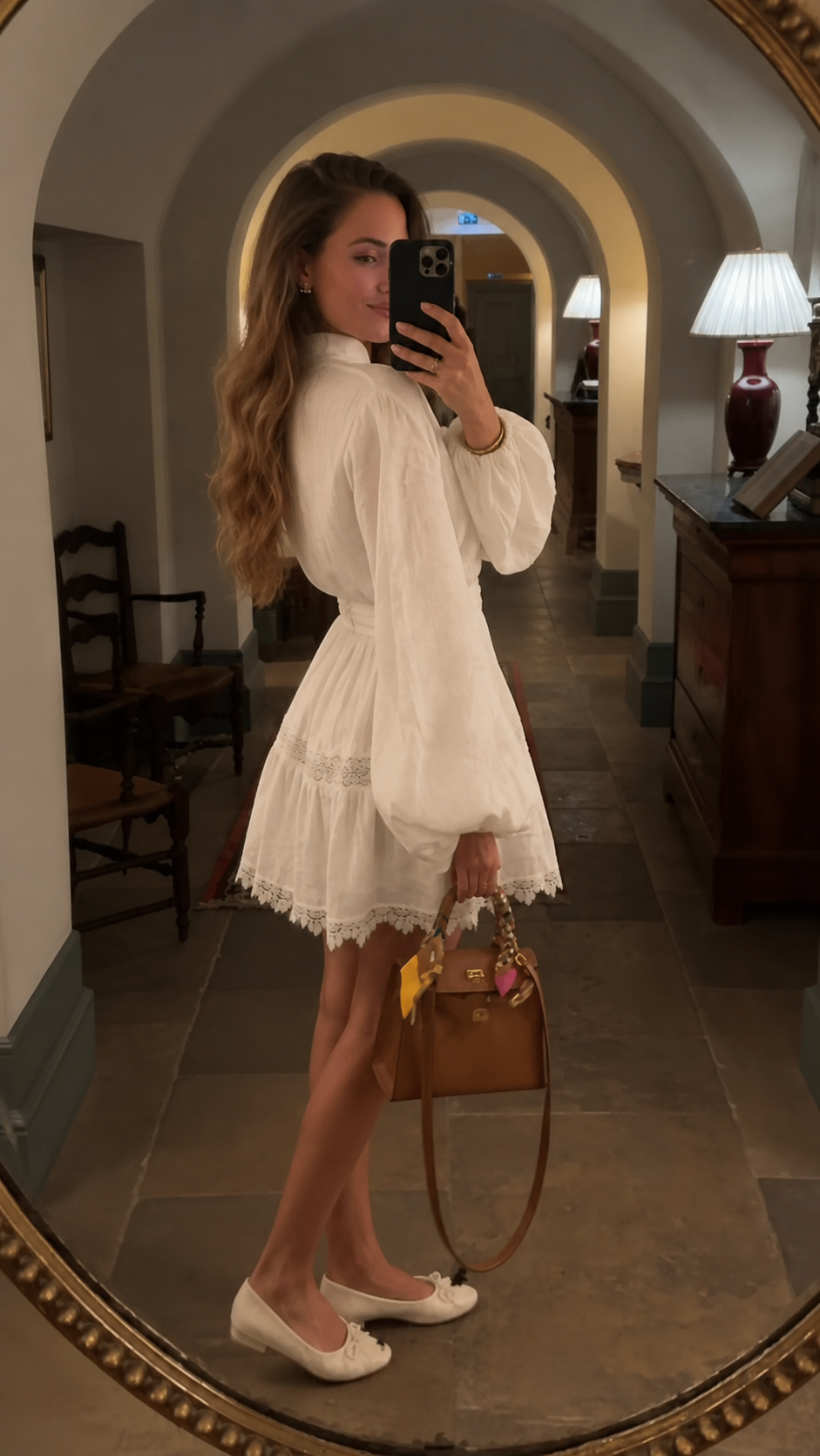 White romantic mini dress side view showing puff sleeves and tiered lace skirt