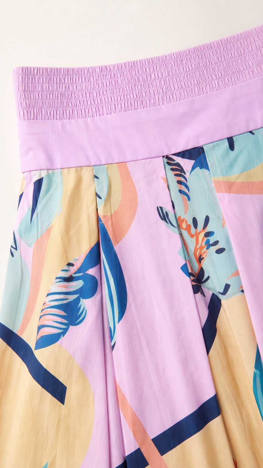 Close-up detail of the pink dress smocked bandeau and abstract pattern