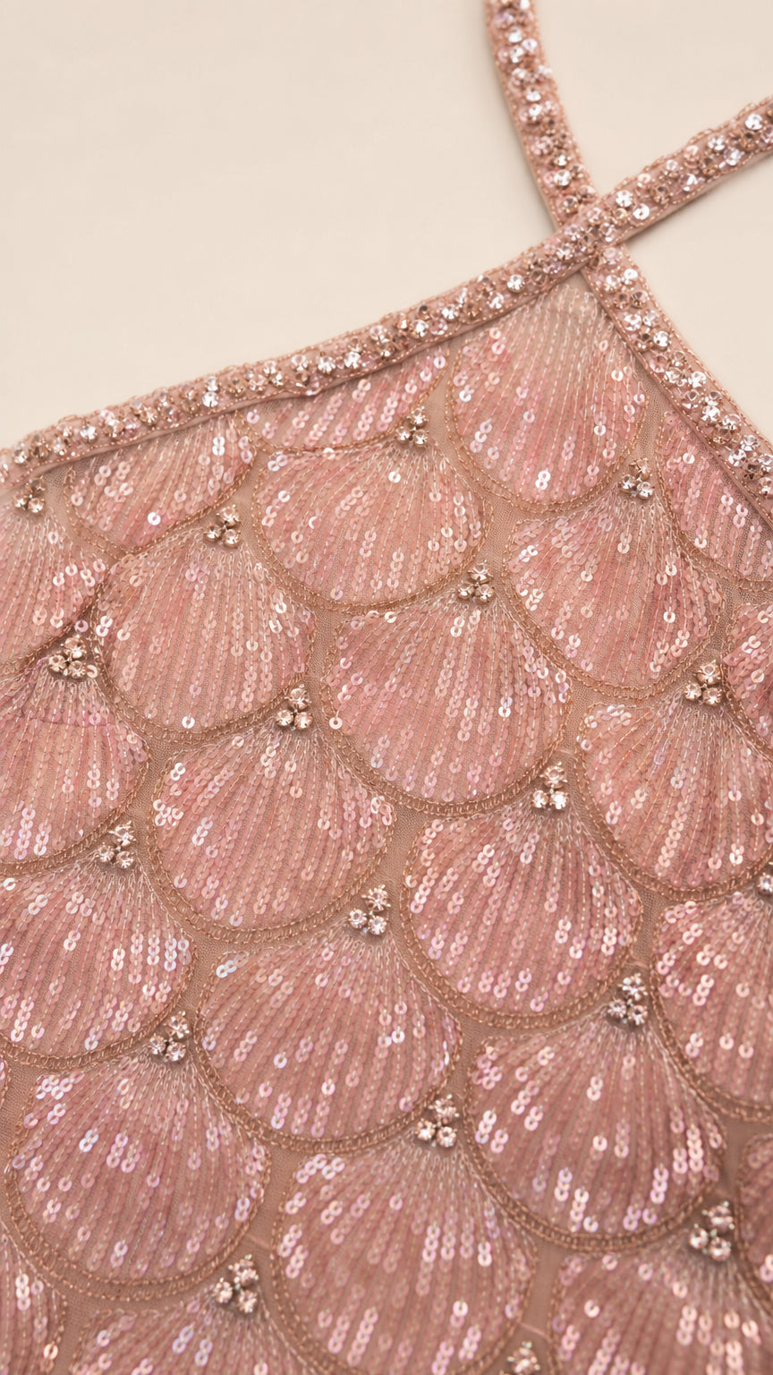 Close-up detail of scalloped sequin pattern and beaded halter strap