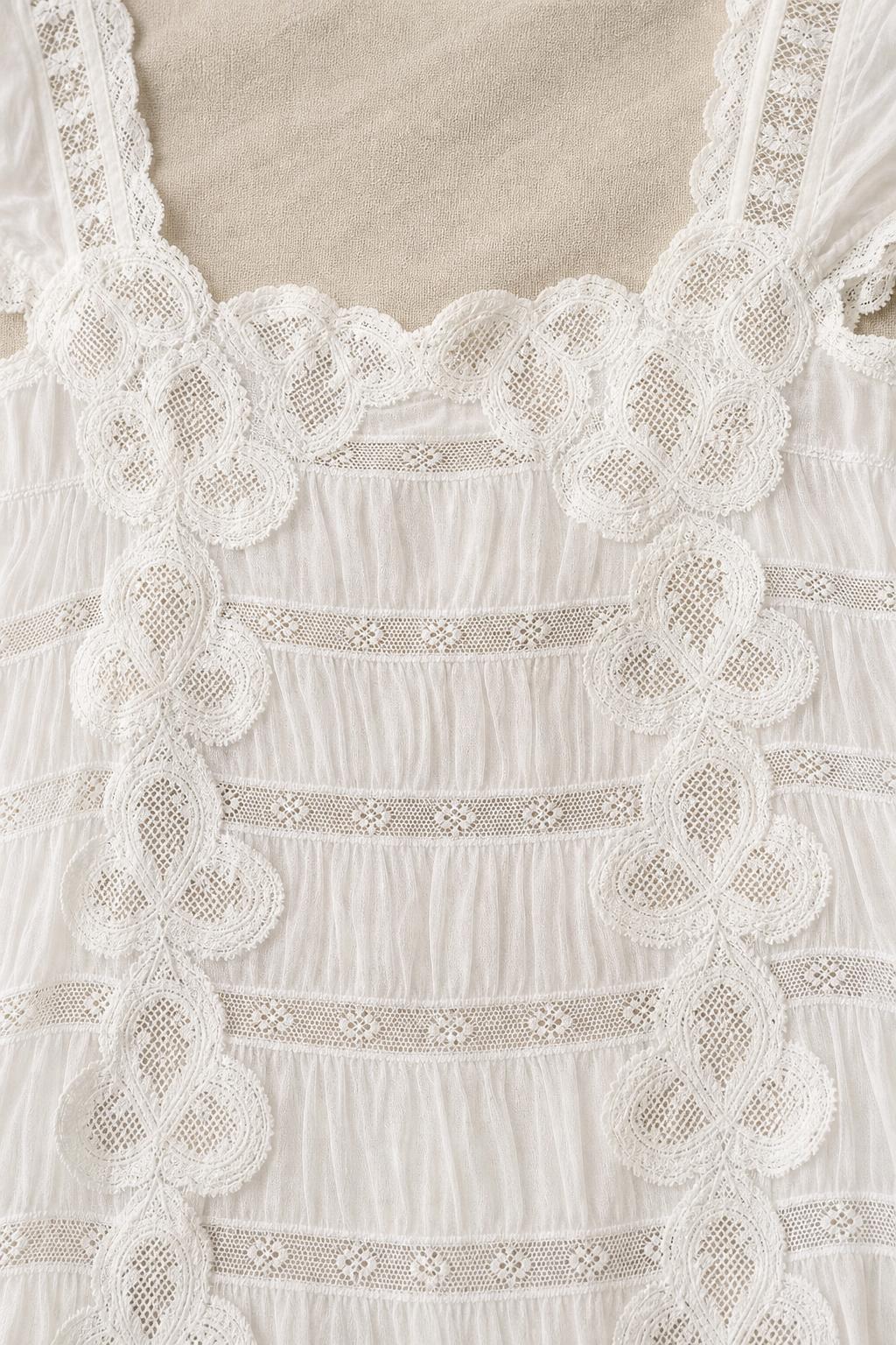 Close-up detail of crochet lace trim and square neckline