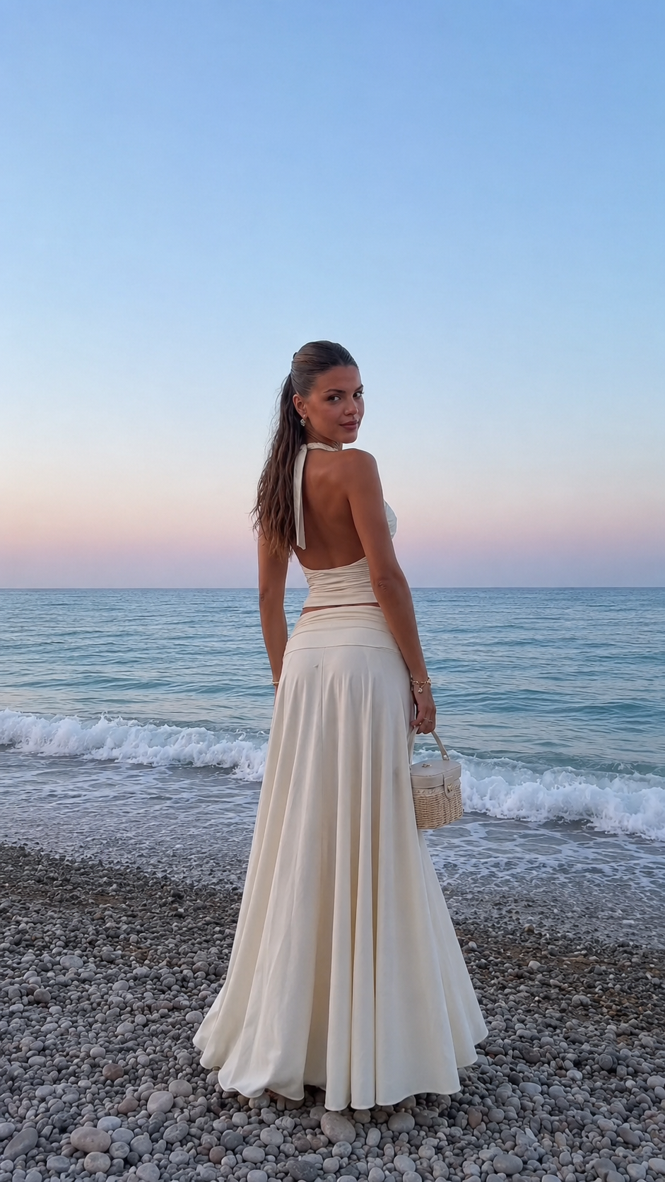 Back view of ivory halter backless top and sweeping maxi skirt set