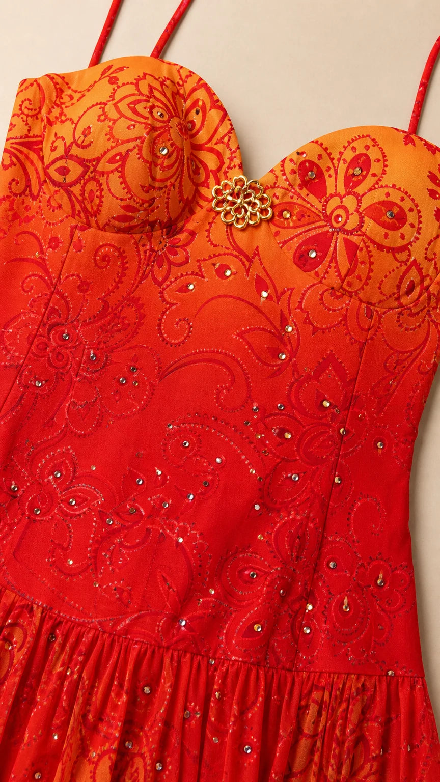 Close-up detail of bodice embroidery, sweetheart neckline, and brooch accent on Red Orange dress