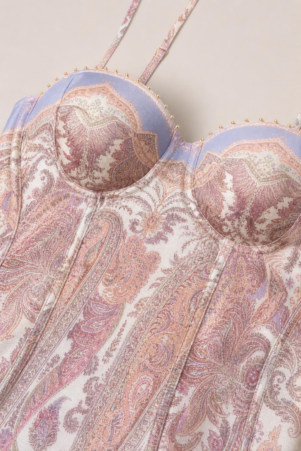 Close-up of structured sweetheart corset bodice with paisley print