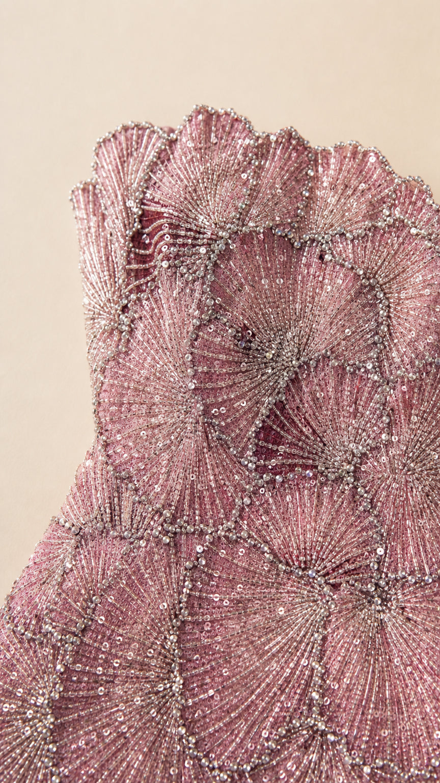 Close-up detail shot of intricate beadwork and scalloped bodice