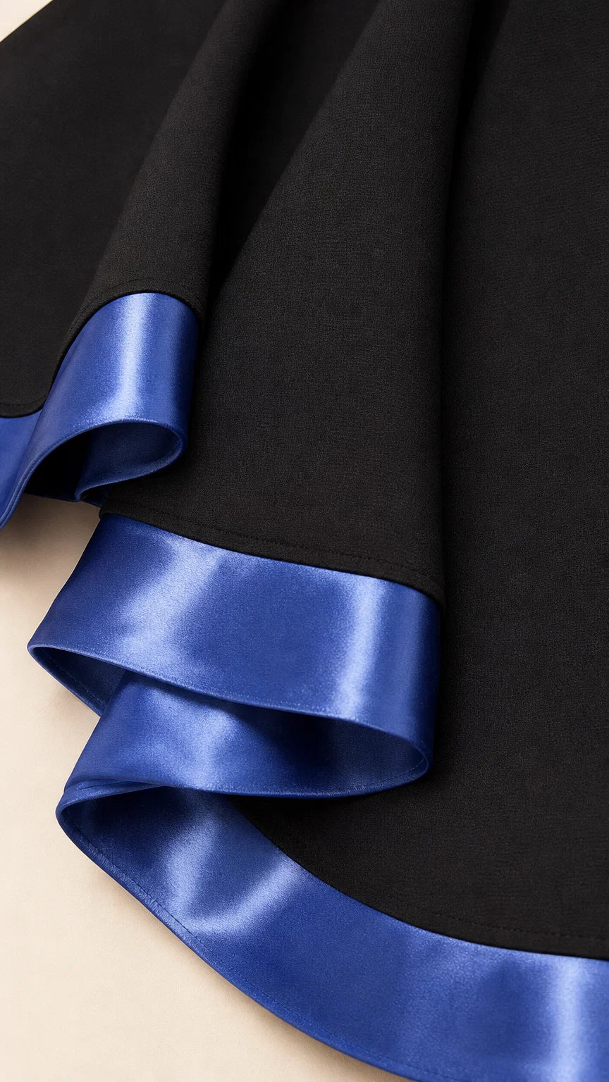 Close-up of smooth fabric and vibrant blue satin hem trim