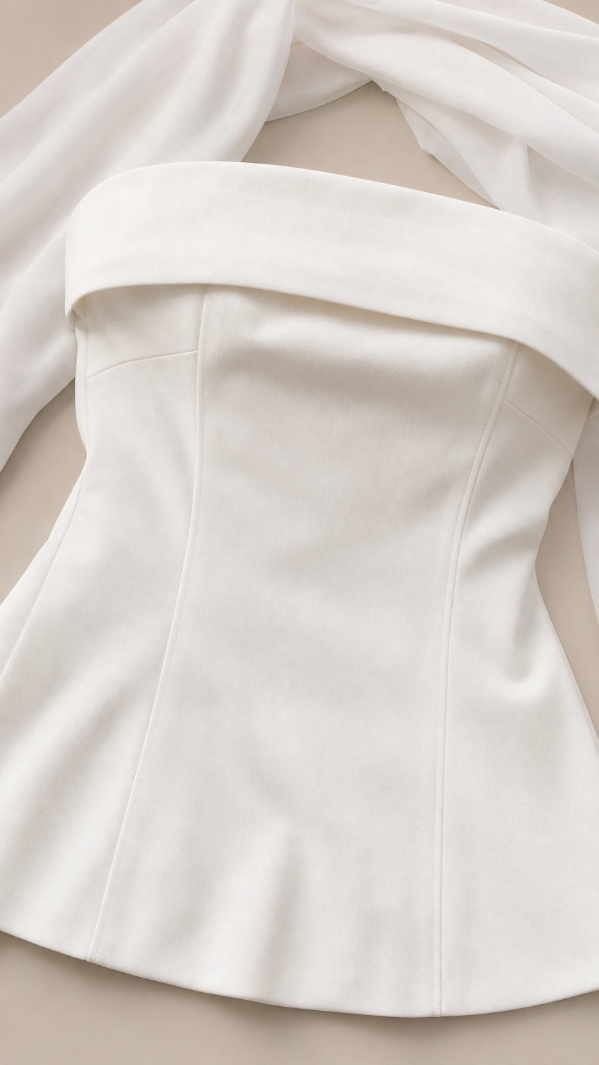 Close-up detail of white strapless bodice and foldover neckline