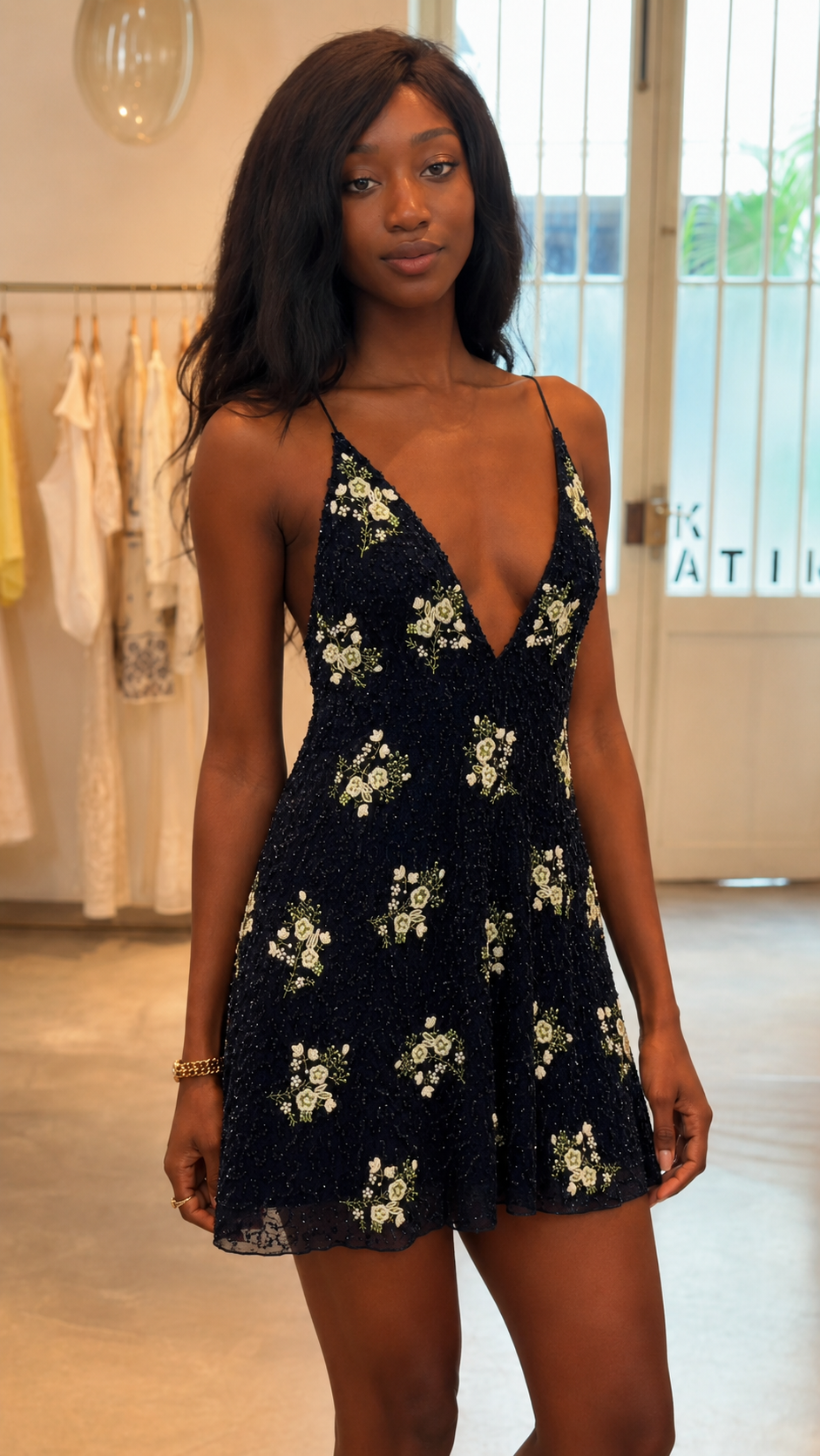 Close-up view of black floral sequin deep V bodice and mini skirt