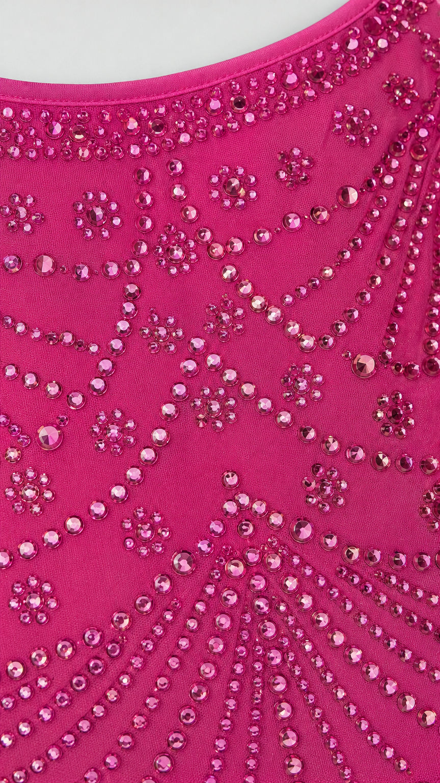 Close-up detail of rhinestone and bead pattern on hot pink fabric