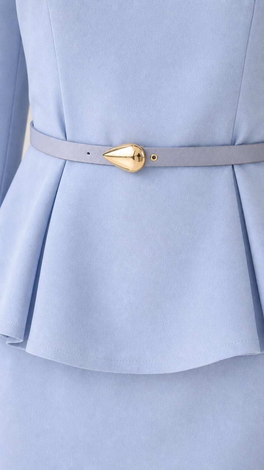 Close-up detail of the peplum waist and gold-accent belt
